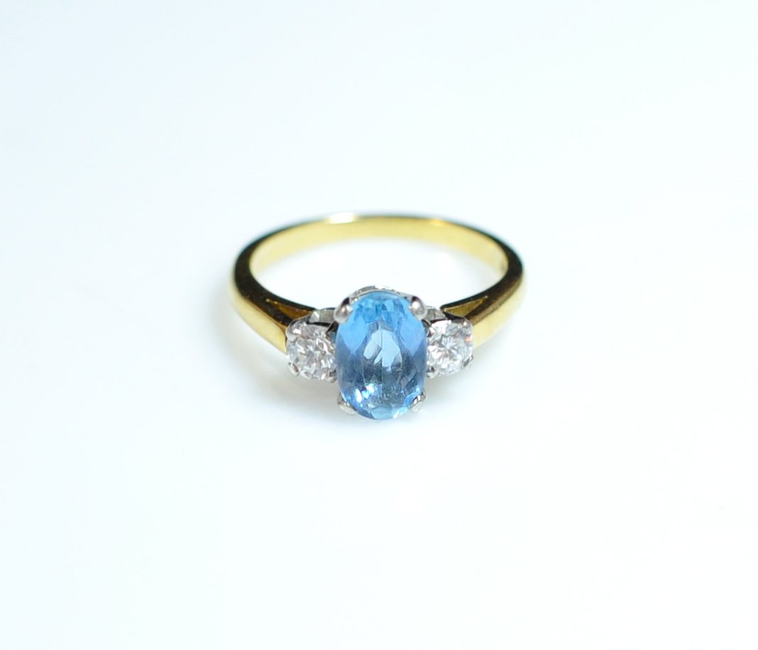 Tiffany Gold Aquamarine & Diamond Ring: DESCRIPTION: DESCRIPTION: 18k yellow gold ladies ring finished in a platinum grid with a beautiful 3.5ct oval aquamarine surrounded by a pair of 0.2ct diamonds. Marked on the interrior "Tiffany & Co" 