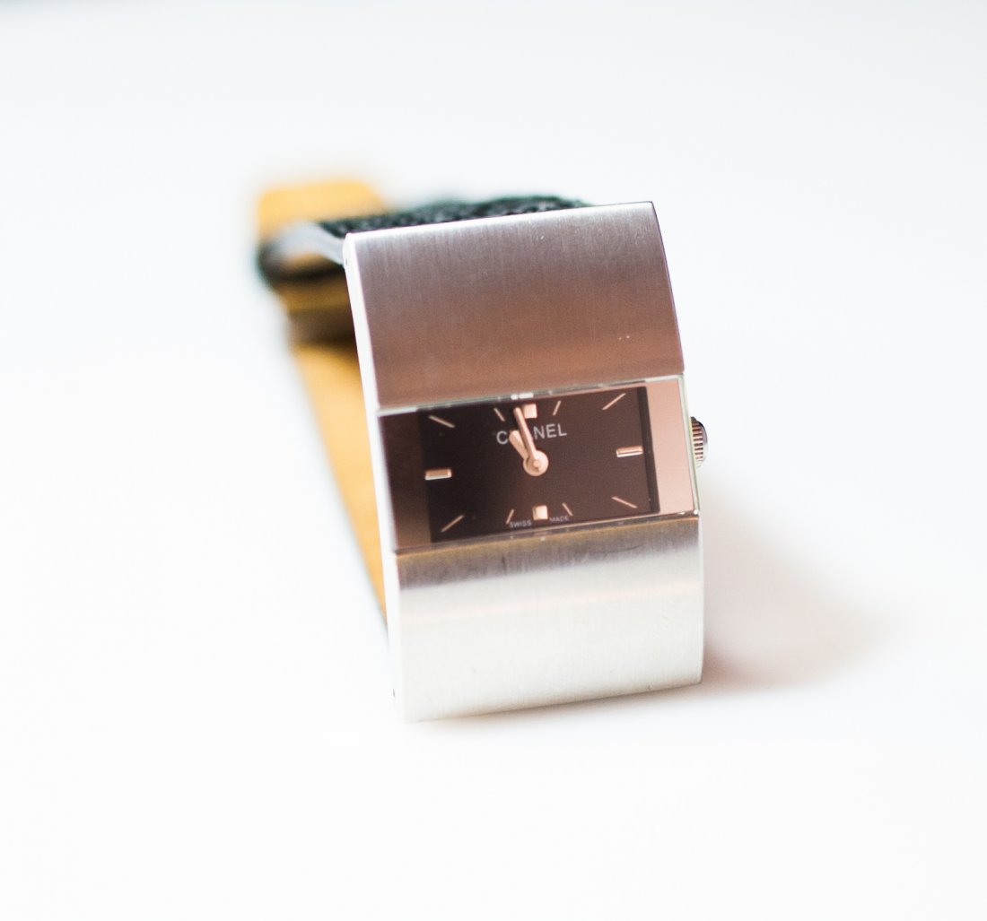 Vintage Chanel Watch: DESCRIPTION: Vintage stainless steel Chanel watch features a modern minimalist look with a black dial. The leather band has a black snake print. Back marked "Chanel France" CIRCA: Mid to late 20th Ct.