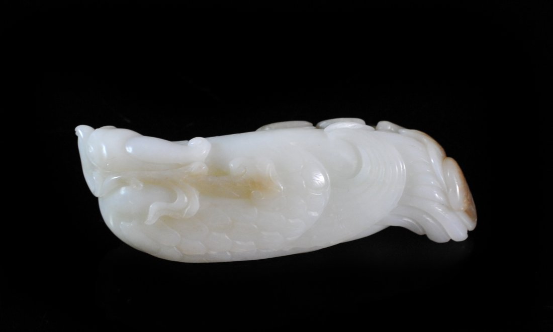 Chinese White Jade Resting Bird: DESCRIPTION: Chinese white jade resting bird, hand carved bird at rest superb color with good detail. With some brownish spotting in matrix. ORIGIN: China DIMENSIONS: H: 1.25" L: 4.5"