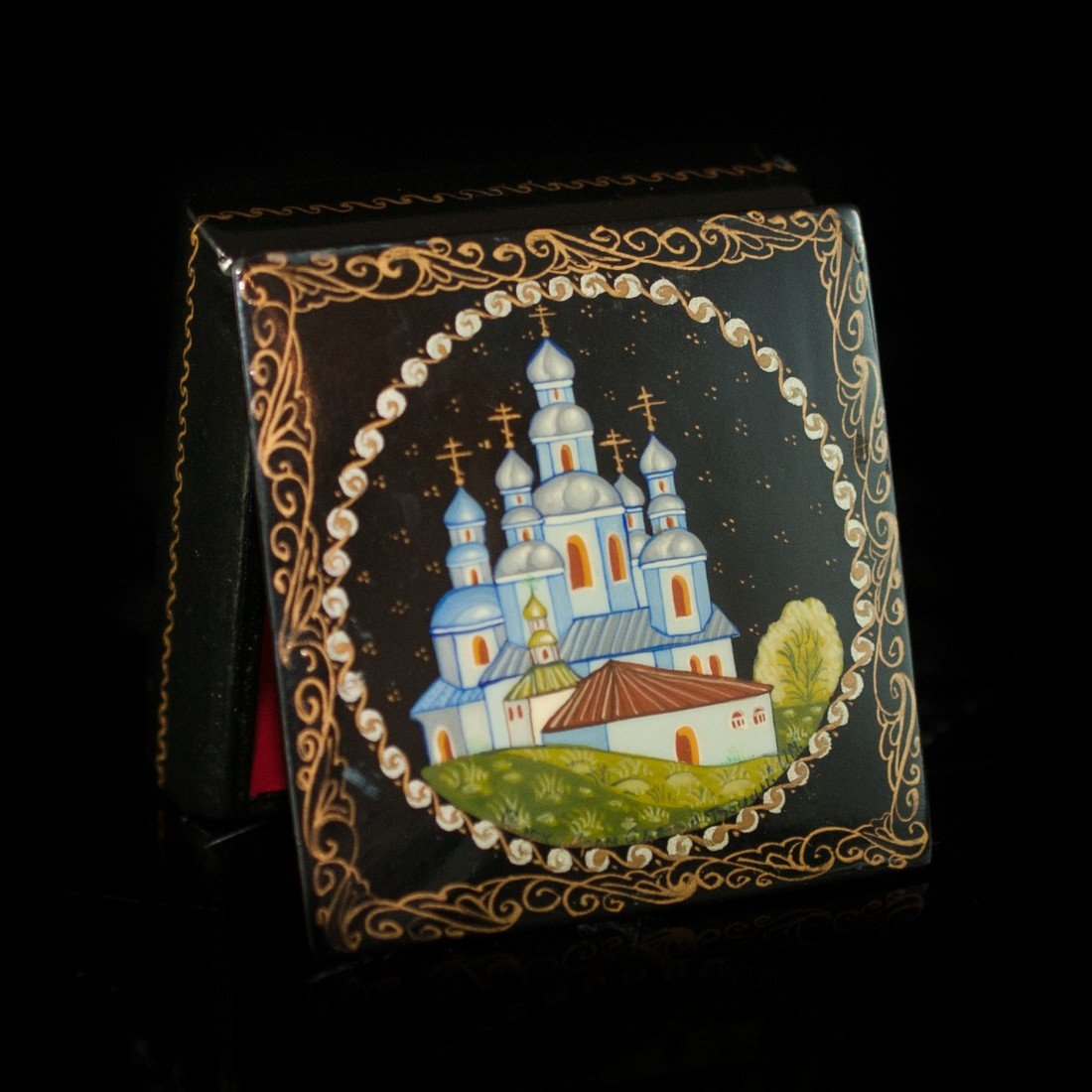 Russian Lacquered Box: DESCRIPTION: Russian hand painted lacquered box. Lid of box completely hand painted with dipiction Saint Basel catherdrals. Gold leaf design on all four sides, interior and exterior laquer with interi
