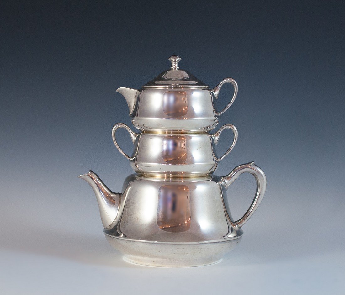 Crescent Silver Tea Set: DESCRIPTION: Vintage silver plated stacking teapot, creamer and sugar set. The unique set features sleek minimalist design with a lidded creamer which mounts over a sugar bowl and teapot. Marked on th