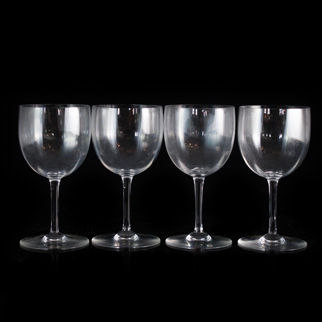 Set of Baccarat Crystal Glasses: DESCRIPTION: A set of four Baccarat deluxe size crystal wine glasses that were made in the 1920s. The iconic circular logo, labeled Baccarat and France, is displayed on the bottom of the glasses with 