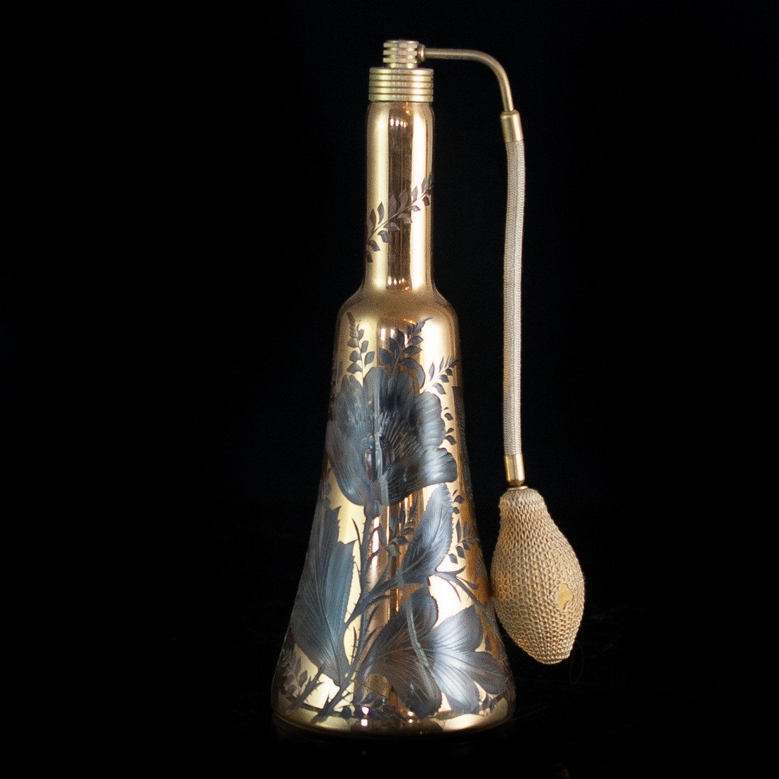 Irice Golden Perfume Bottle: DESCRIPTION: This glass perfume bottle, created by IRICE in the 1950s, has no chips or scratches, and the original sticker is still on the bottom of the bottle. It has a metallic golden background wit