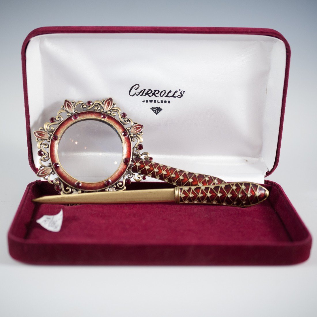 Silver & Enamel Ladies Desk Set: DESCRIPTION: Sterling silver ladies desk set features a letter opener and magnifying glass. The set is is decorated with red enamel and synthetic cabochon rubies. Comes in original box. CIRCA: Mid 20t