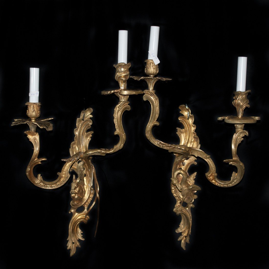 Figural Gilded Bronze Sconces: DESCRIPTION: Pair of gilded bronze sconces in a beautiful bright golden patina. the sconces feature floral motifs with a figural squirrel centered between two candle arms. The candle arms are finished