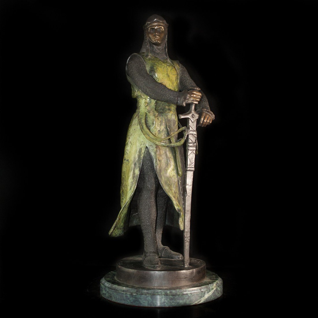 Maurice Favre Bronze Knight: DESCRIPTION: bronze sculpture after artist Maurice Favre (1876-1954). The piece is masterfully cast with a deep rich green and brown patina in a two tone patination. The figure depicts a young and pro