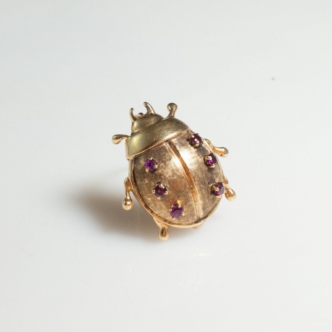 Tiffany & Co. Gold & Ruby Brooch: DESCRIPTION: Vintage 14k yellow gold brooch depicting a beatle with beautiful detalils through out the back, finished off with six small rubies. Marked on the bottom "Tiffany & Co. 14k" Weight: 7.5 gr