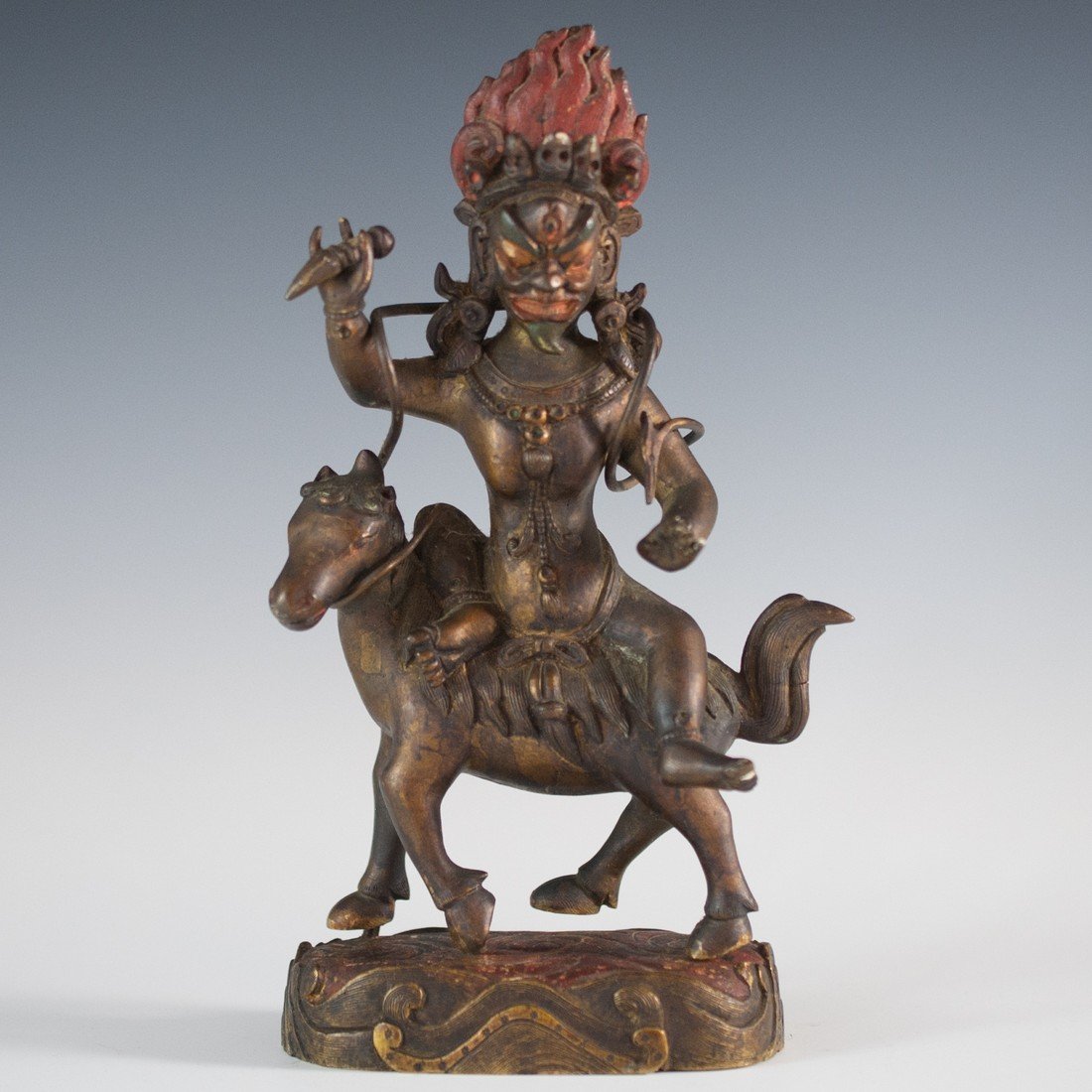 Antique Thai Bronze: DESCRIPTION: Bronze figure in a dark brown patina depicts the Hindu deity Shiva in his zoomorphic form atop of a horse. The bronze is attached to a base which was used as a compartment to place prayer