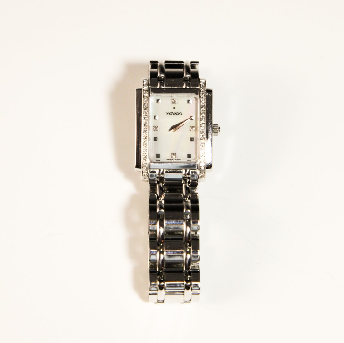 Movado Sika Ladies Gold Watch: DESCRIPTION: Movado Sika Ladies 14 Karat White Gold Diamond Watch. The watch features Swiss Quartz movement, Sapphire crystal , White mother-of-pearl dial, 14K white gold case with diamond bezel and 1