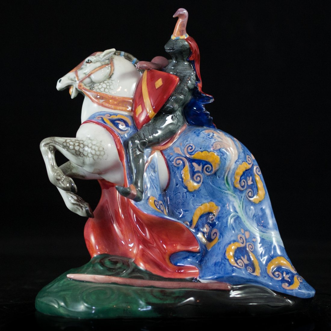 Royal Doulton "The Broken Lance": DESCRIPTION: Royal Doulton "The Broken Lance" knight figurine. Hand painted knight in full armor with shield and lance on charging white horse. Hallmarked "Royal Daulton. Made in England The Broken La