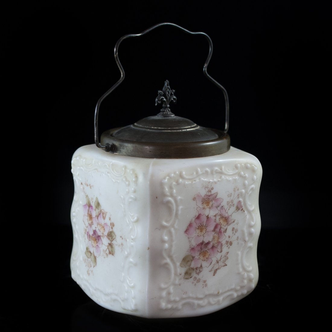 Vintage C.F Monroe & Co Jar: DESCRIPTION: Porcelain biscuit jar from American comapany C.F Monroe & Co. features a white gorund color with hand painted floral decorations on each side. The top includes a brass handle and top. CIR