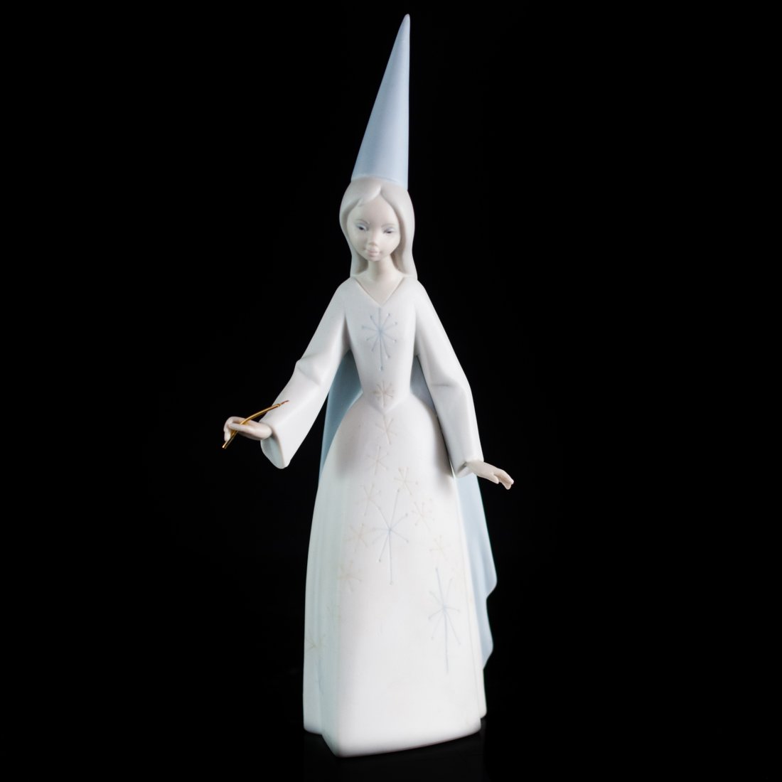 Lladro Fairy Figurine: DESCRIPTION: Lladro "Fairy" Figurine features in hues of light blue, the figure holds a gold starred wand Issued Year 1970 Retired 1994 Glaze Finish Sculptor: Antonio Ruiz Marked on bottom "Lladro mad