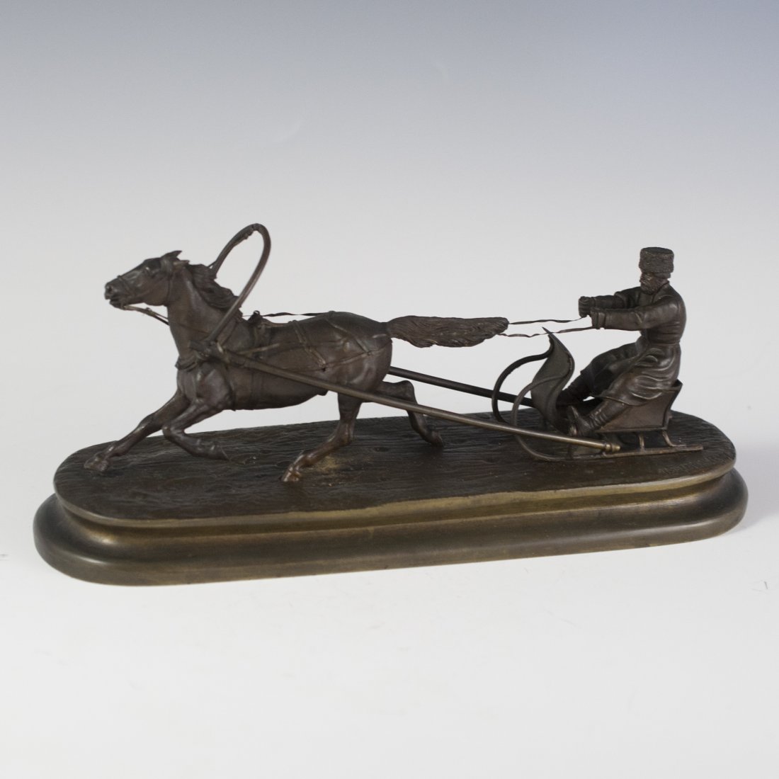Bronze by Vassili Grachev (Russian 1831-1905): DESCRIPTION:Bronze sculpture by Vassili Grachev cast in the Woerffel Foundry. Features a man handling a sleigh being pulled by a gallant, galloping horse. Marked in Russian "Vasili Grachev" along the