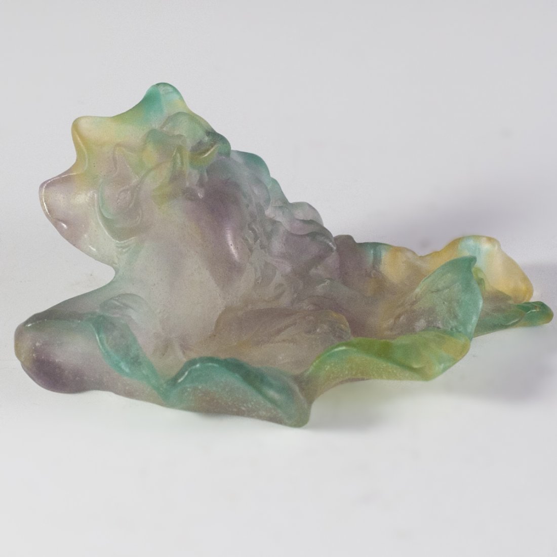 Daum Pate De Verre Crystal Ashtray: DESCRIPTION:Figural pate de verre crystal ashtray by Daum. Features a verdant, leaf motif with rolling edges and wrinkles as well as the relief of a smiling maiden looking to her left. Finished in lav