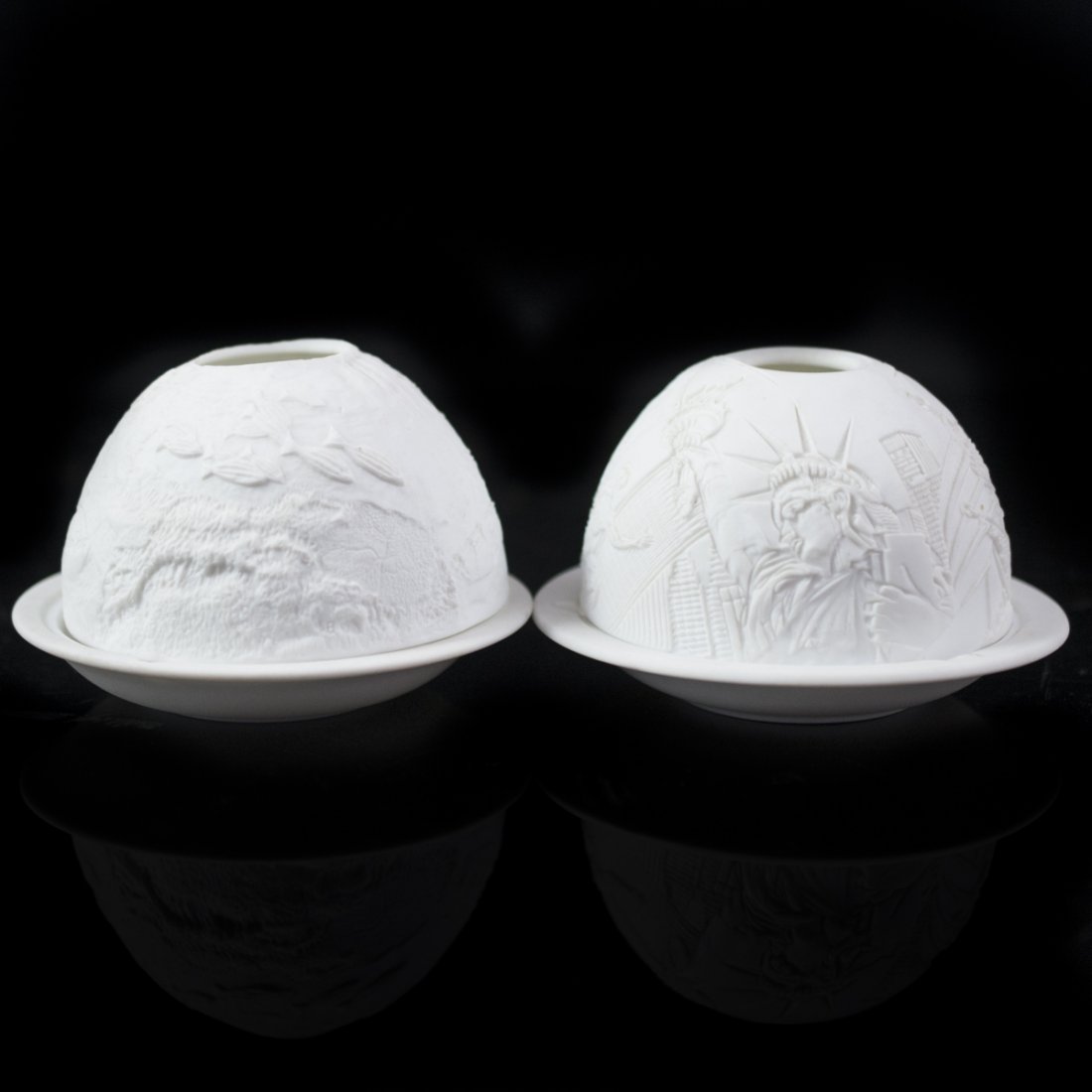 Bernardaud Limoges Candle Globes: DESCRIPTION:Bernardaud Limoges porcelain candle globes. One features embossed illustrations of the New York skyline including the Statue of Liberty, the Empire State Building and other iconic skyscrap