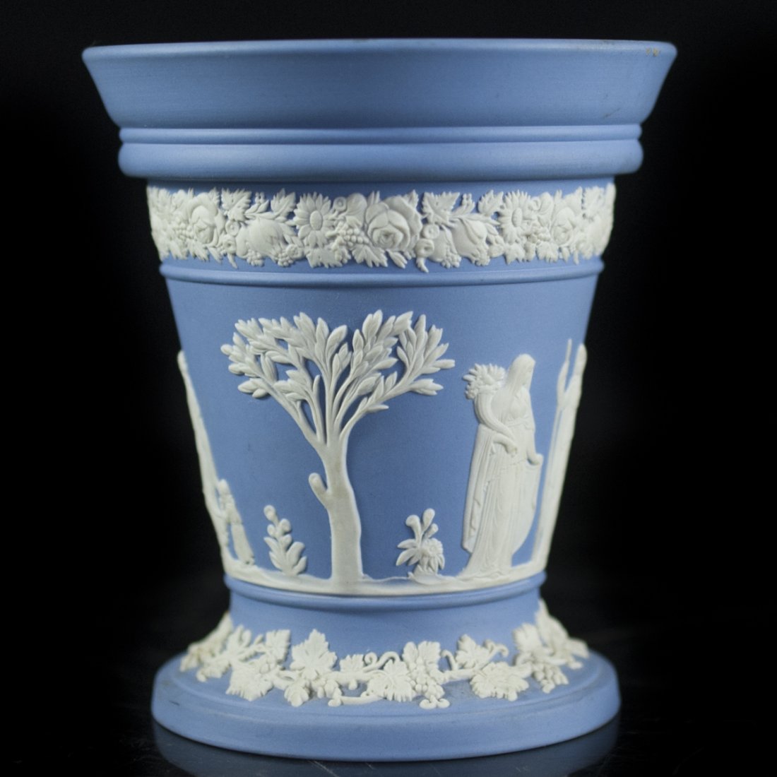 Wedgwood Blue Jasperware Vase: DESCRIPTION:Wedgwood blue jasperware vase. Embellished with Greco-Roman depictions of Gods, Godesses, and cherubs and finished with a perforated lid to seperate flower stems. Marked on bottom:"Wedgwoo