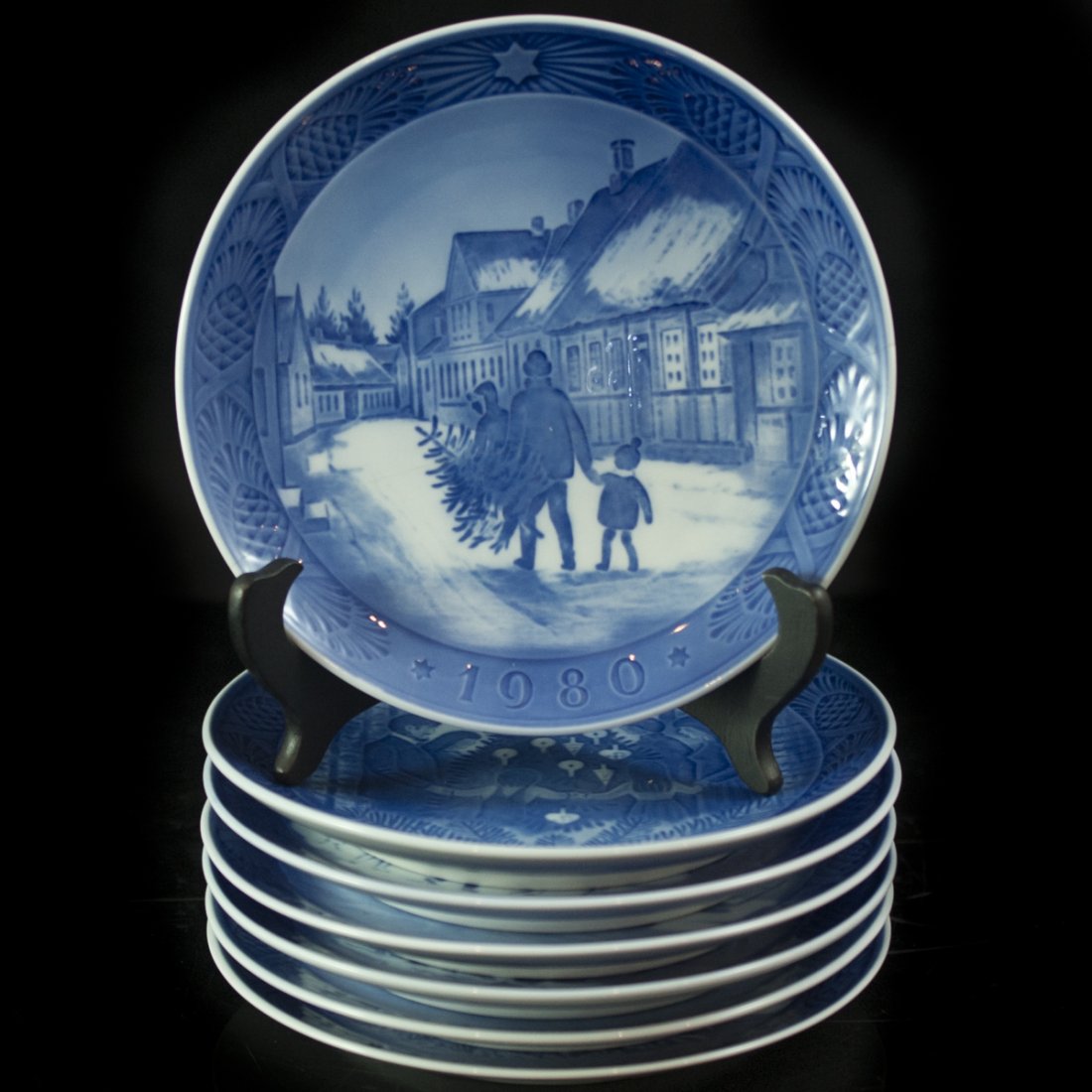 Royal Copenhagen Annual Plates: DESCRIPTION:Annual limited edition porcelain dishes by Royal Copenhagen. Comprises of 7 plates with the following year: 1976, 2 1978, 1980,1983, 1990, & 1996. Each are painted with an array of scenes