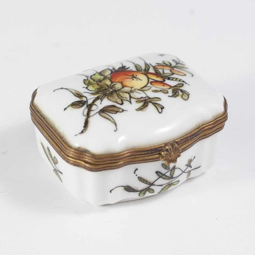 French Porcelain Pill Box: DESCRIPTION:French porcelain pill box handpainted with blossoming fruits and flowers and fitted with a brass hinge that opens to reveal handpainted floral motif interior. Signed on the bottom in cursi