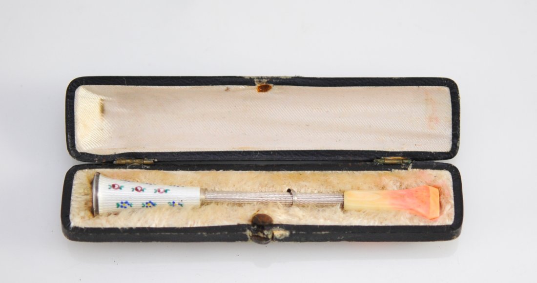 Antique French Enameled Silver Cigarette Holder: DESCRIPTION: Antique French silver, enamel and bone cigarette holder. Hand carved mouth piece with a slight lipstick stain, sterling shaft and cigarette holder done in guilloche white enamel with mini