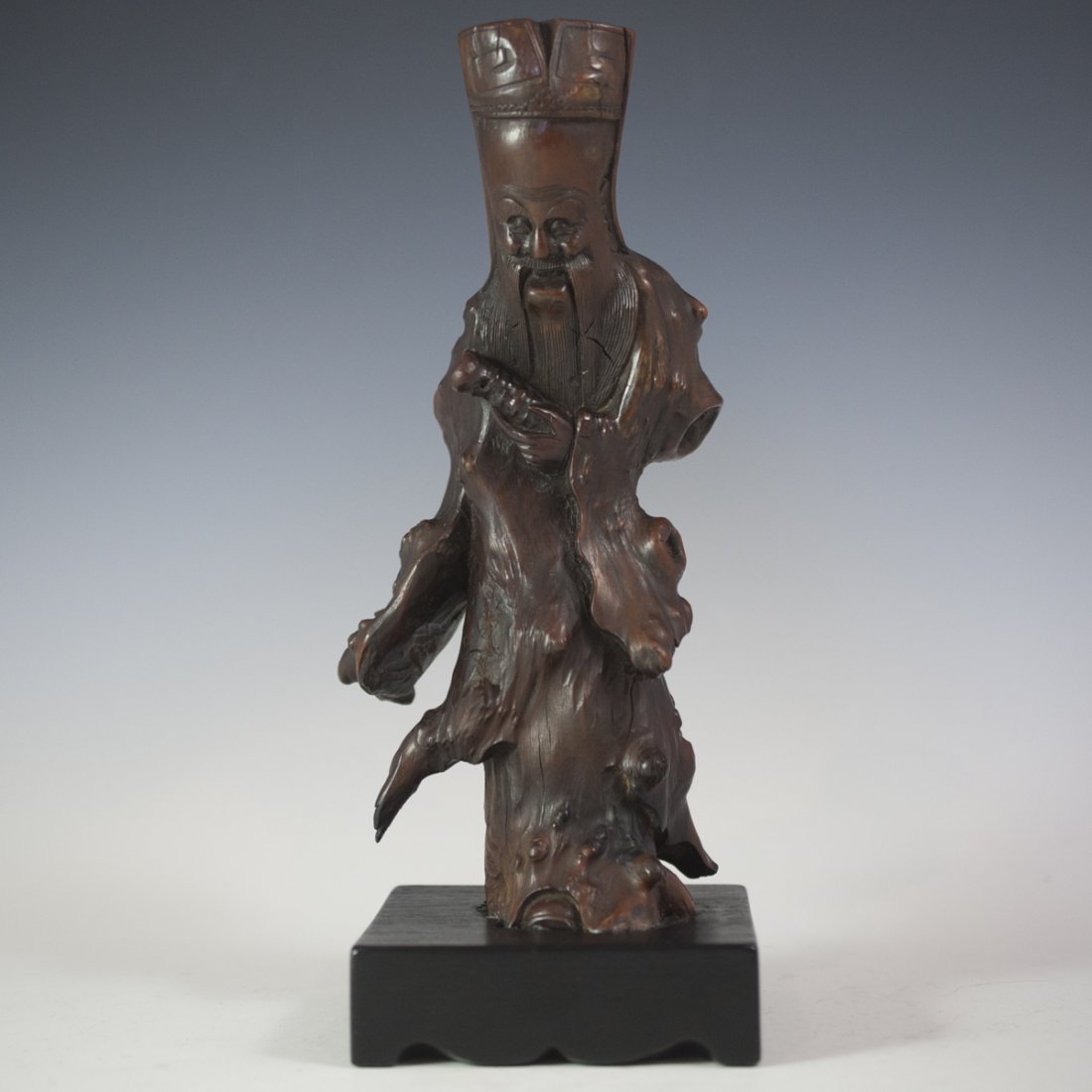 Antique Chinese Wooden God of Longevity: DESCRIPTION: Antique Chinese wood sculpture of the Chinese deity of longevity. Seen here with a carved head piece and long flowing beard. Tapers down to an abstract flowing body. CIRCA:19th|20th Ct. O