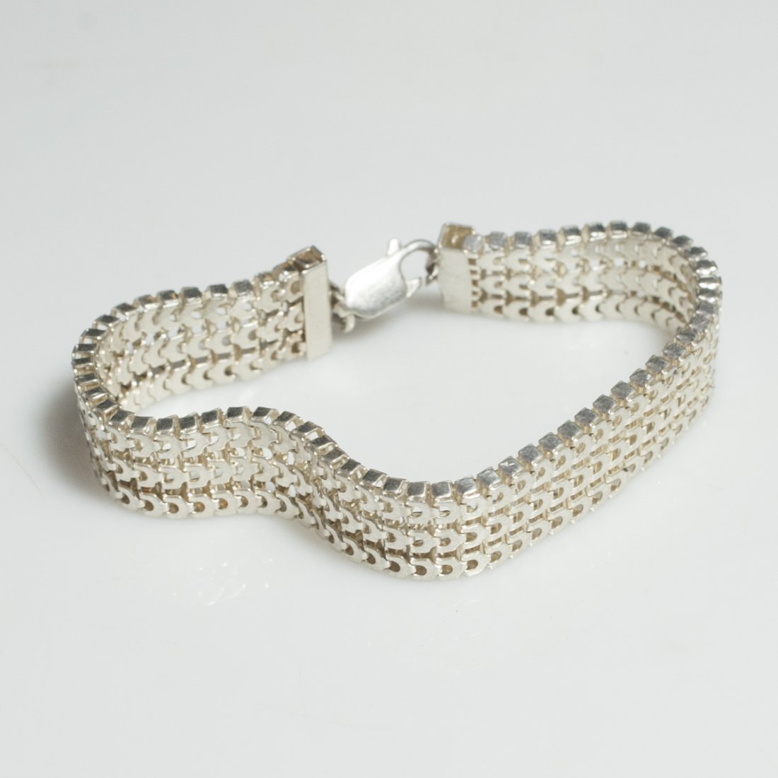 Sterling Men's Bracelet: DESCRIPTION:Men's sterling bracelet comprising of three rows of segmented sterling chains convening at lobster claw clasp. Marked:"925" CIRCA:20th Ct. ORIGIN:Unknown DIMENSIONS:(Closed) L:7.5" Total W