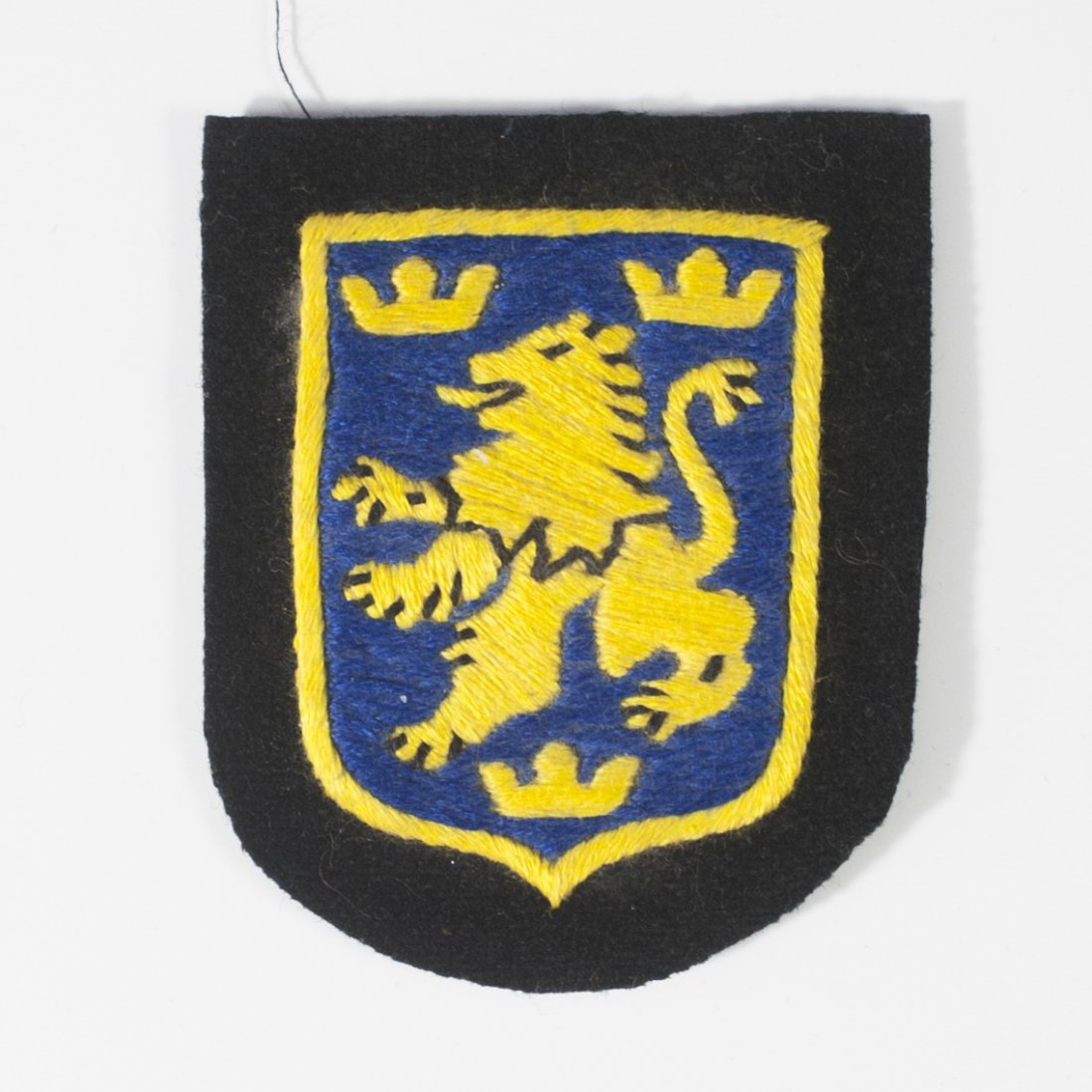 Ukrainian Nazi Volunteer Hersteller Sleeve Shield: DESCRIPTION:Sleeve Shield from the Hersteller Ukrainian German volunteer 14th Waffen SS Galician Division. Marked on back:"Hersteller Reichszeugmeisterei der DSDAP. L No 3002" CIRCA:Mid 20th Ct. ORIGI