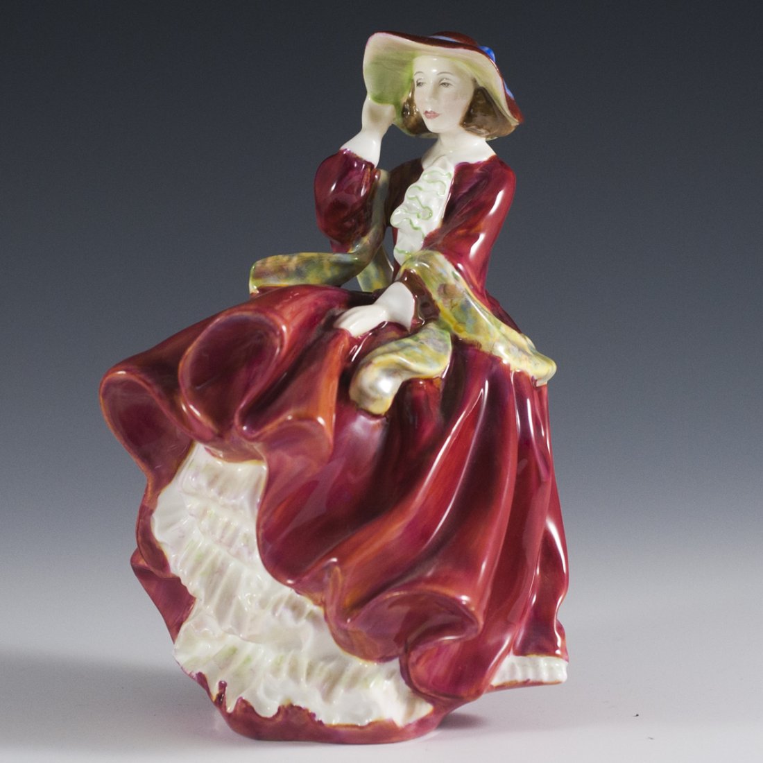 Royal Doulton FigurineÊ"Top O' the Hill": DESCRIPTION:Vintage Royal Doulton Figurine Of Woman in Red Dress Titled "Top O' the Hill" .Makers Stamp to Base of Figure. Like New Condition. Stamped "Corp 1937" CIRCA: 20th Ct. ORIGIN:England DIMENS