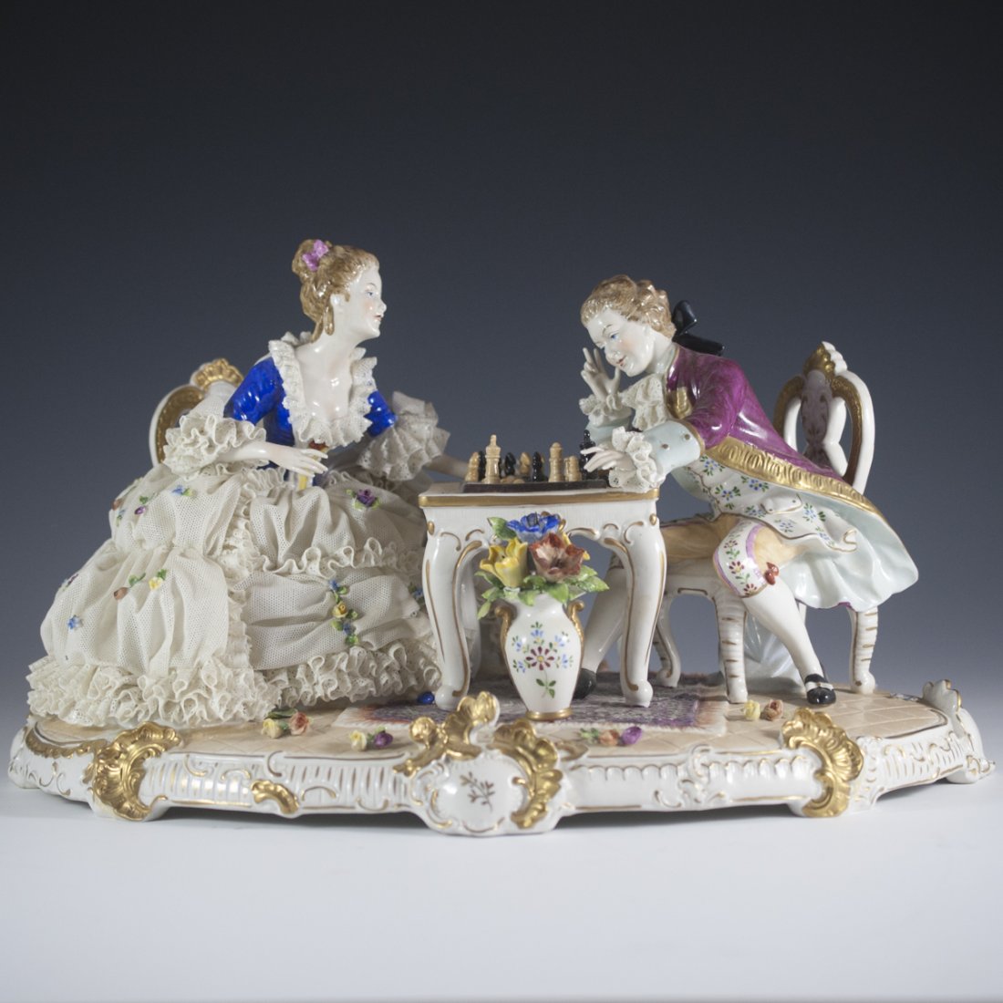 United Weiss Bach Porcelain Chess Sculpture: DESCRIPTION: United Weiss Bach Porcelain sculpture depicts a magnificent scene of courting couples concentrated on a game of chess. The porcelain is hand painted in detail with realistic expressions,