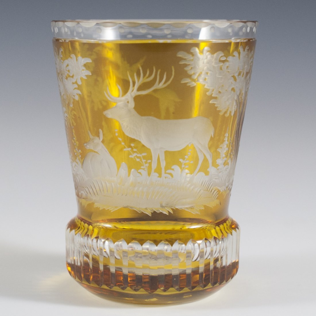 Etched Bohemian Amber Glass Beaker: DESCRIPTION:Etched Bohemian amber glass beaker. Features etched rendering of soaring ducks, and deers resting amongst high grass along with highly detailed trees and foliage. Finished with dotted and 