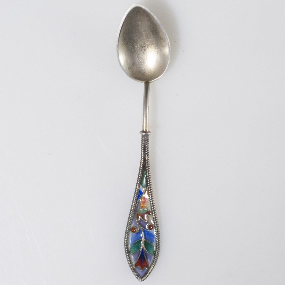 Miniature Sterling Enamel Sugar Spoon: DESCRIPTION: Miniature sterling sugar spoon featuring cabled roped accents along the handle and enameled floral designs. Marked:"Sterling IH&Co" CIRCA: 20th Ct. ORIGIN: Unknown DIMENSIONS:L:3" Total W