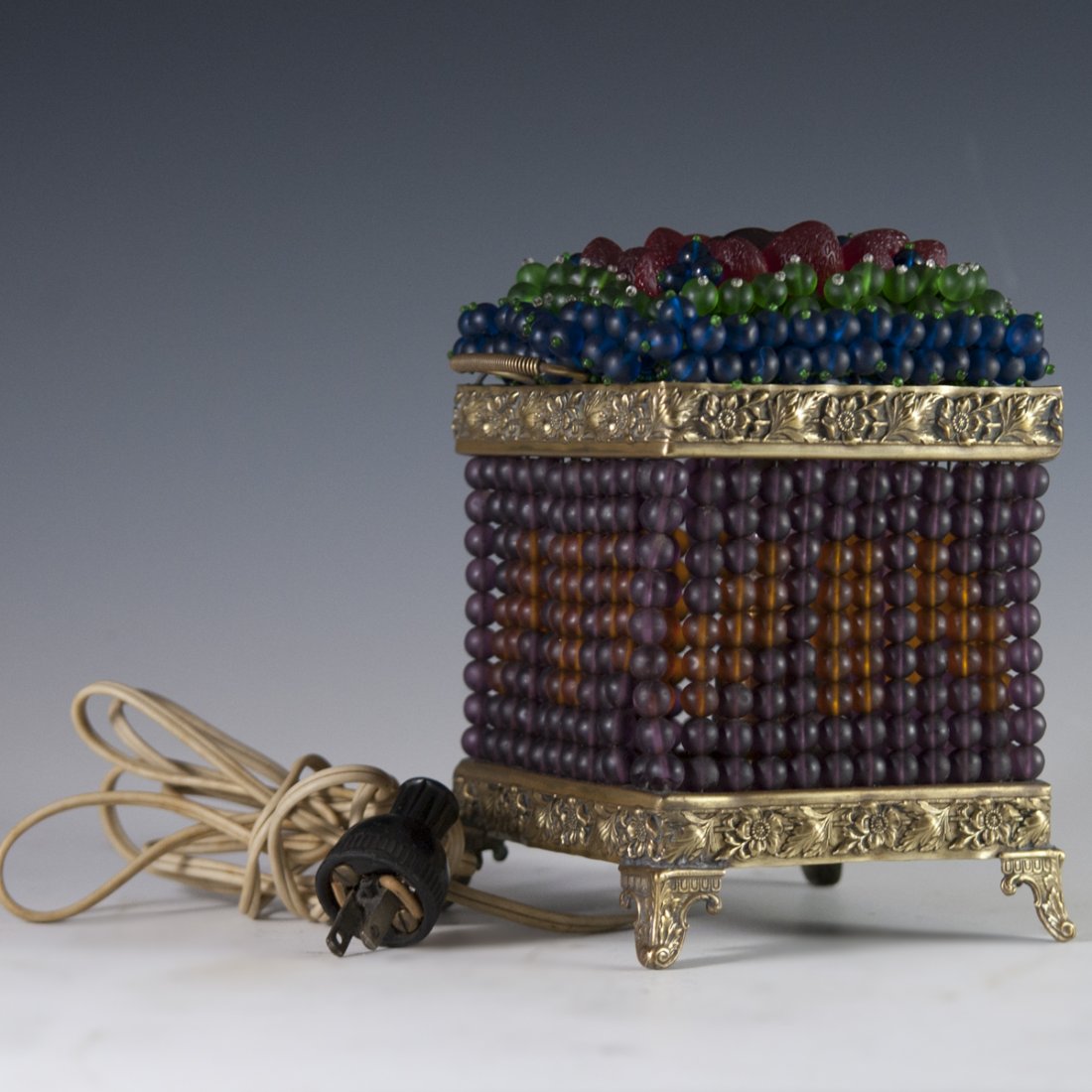 Czech Glass & Brass Art Deco Lamp: DESCRIPTION: Czech glass and brass Art Deco lamp. Features Czechoslovakian glass beads in the motif of berries, encompassing the center strawberries, cherries, and blueberries. Fitted with embossed fl
