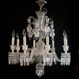 Baccarat Crystal "Zenith" Chandelier: DESCRIPTION: A Baccarat crystal "Zenith" pattern chandelier. Features a metal rococo floral motif canopy what an overall fluted diamond cut crystal stem, with the top enveloped by arching spiraled arm