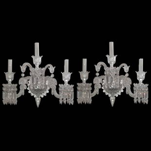 Baccarat Crystal "Zenith" Sconces: DESCRIPTION: Pair of Baccarat crystal "Zenith" patterned sconces. Features elegantly diamond patterned cuts, with two spiraled arching arms embellished with hanging crystal prisms along the bottom.