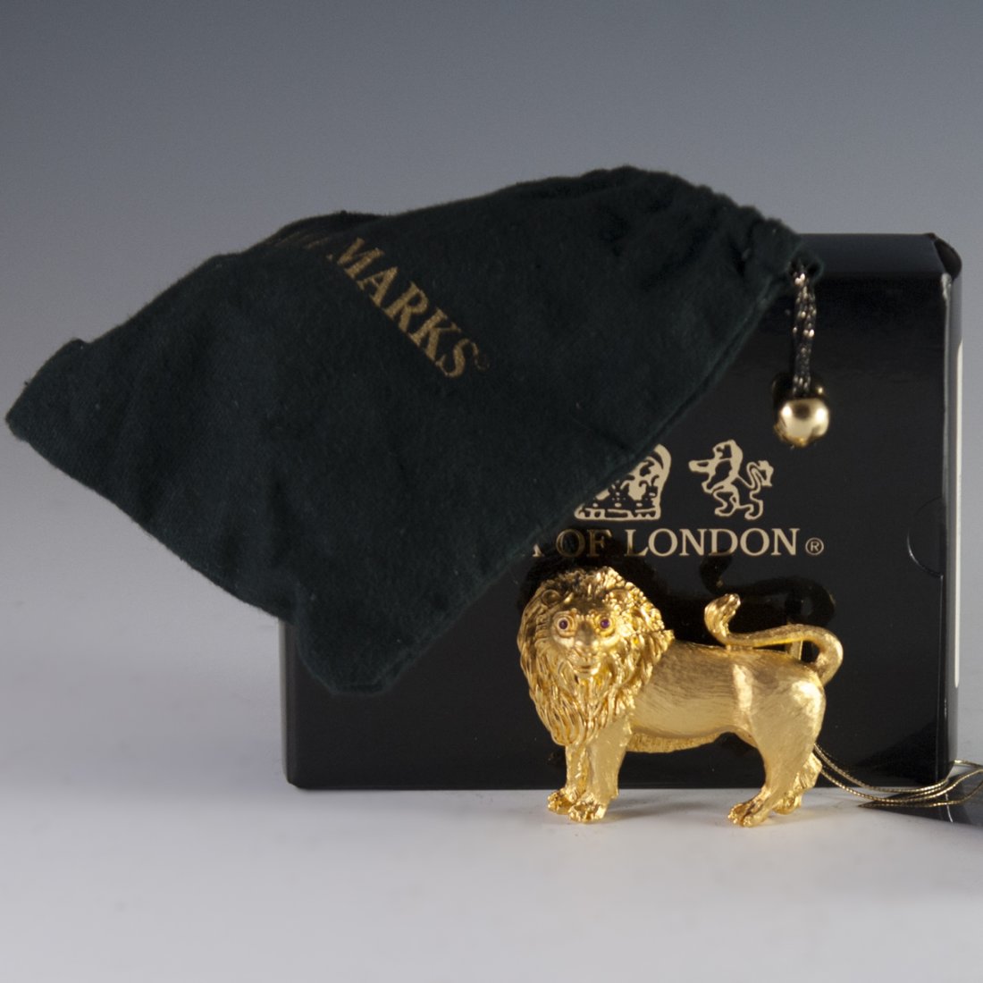 Lana of London Gilded Sterling Belt Buckle: DESCRIPTION: A gilded sterling Lana of London belt buckle in the motif of a zodiac Leo the Lion. Embellished with gilded hue and ruby eyes. Marked:"Lana of London 1992 Sterling". Includes original fel