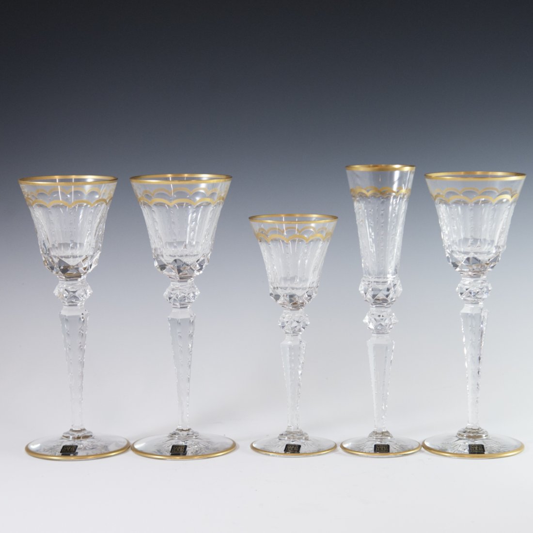 St. Louis Cristal "Excellence" Stemware: DESCRIPTION: Set of 5 St Louis Cristal "Excellence" patterned stemware. Includes: 3 red wine glasses, 1 white wine glass, and one champagne flute. Decorated with elegant geometric cuts along with mold