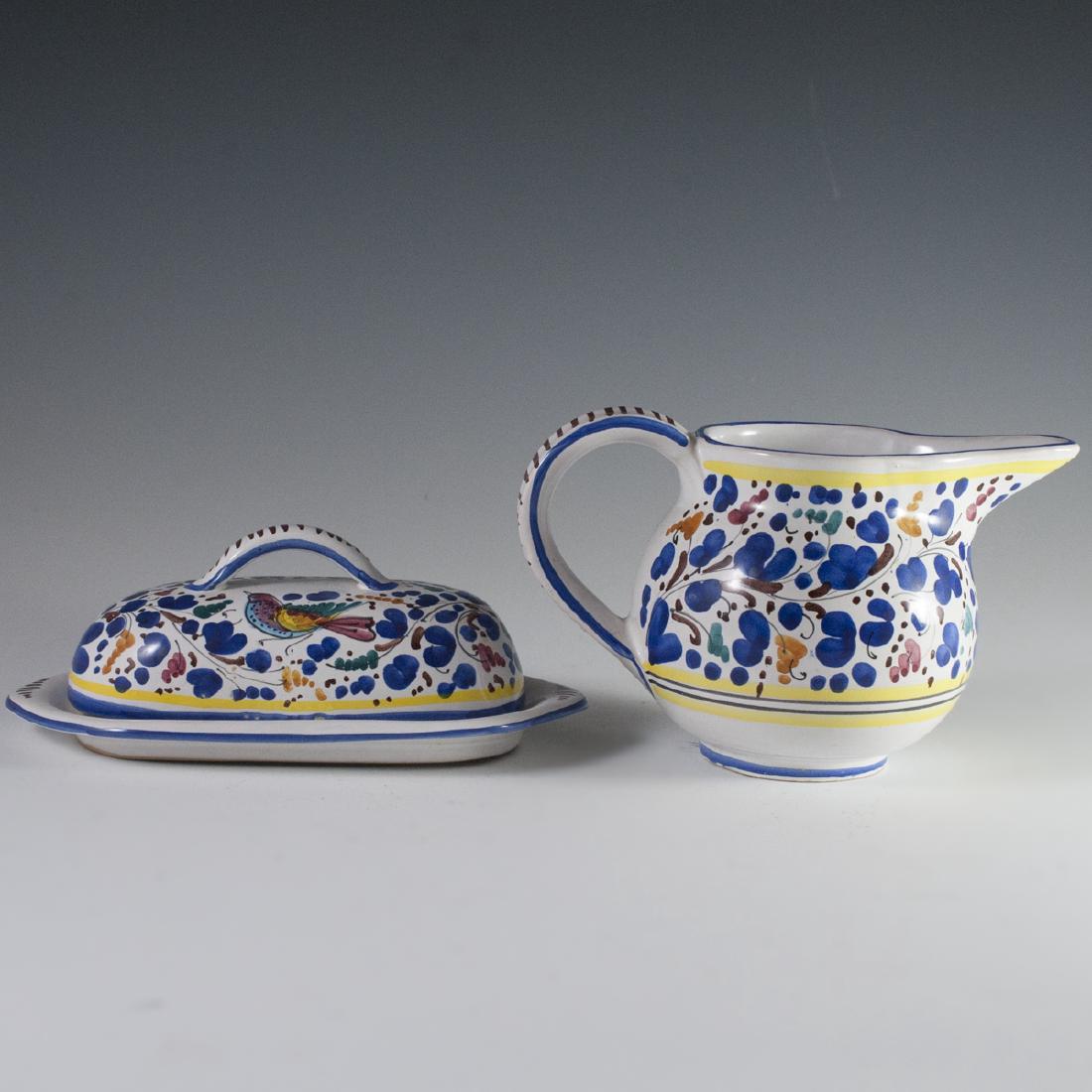Italian Ceramic Set: DESCRIPTION: Italian ceramic set featuring a creamer and a lidded butter dish. Both are handpainted with ornate floral motif and vibrantly hued birds. Marked on bottom with "Food safe" stamp as well a