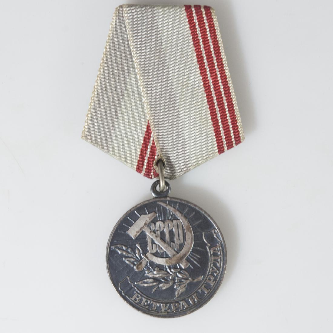 Soviet Veteran of Labour Medal: DESCRIPTION: A Soviet Veteran of Labour medal awarded for workers for many years of hard work in the national economy, sciences, culture, education, healthcare, government agencies and public organiza