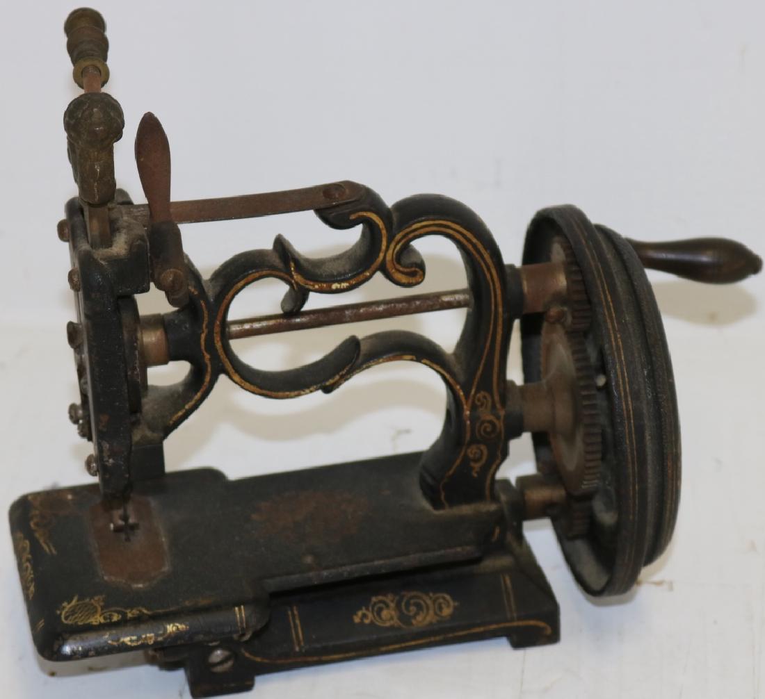 19TH C CHILD'S SEWING MACHINE, CAST IRON.: ORIGINAL FINISH, GOOD CONDITION. 8" HIGH, 9 1/2" LONG.