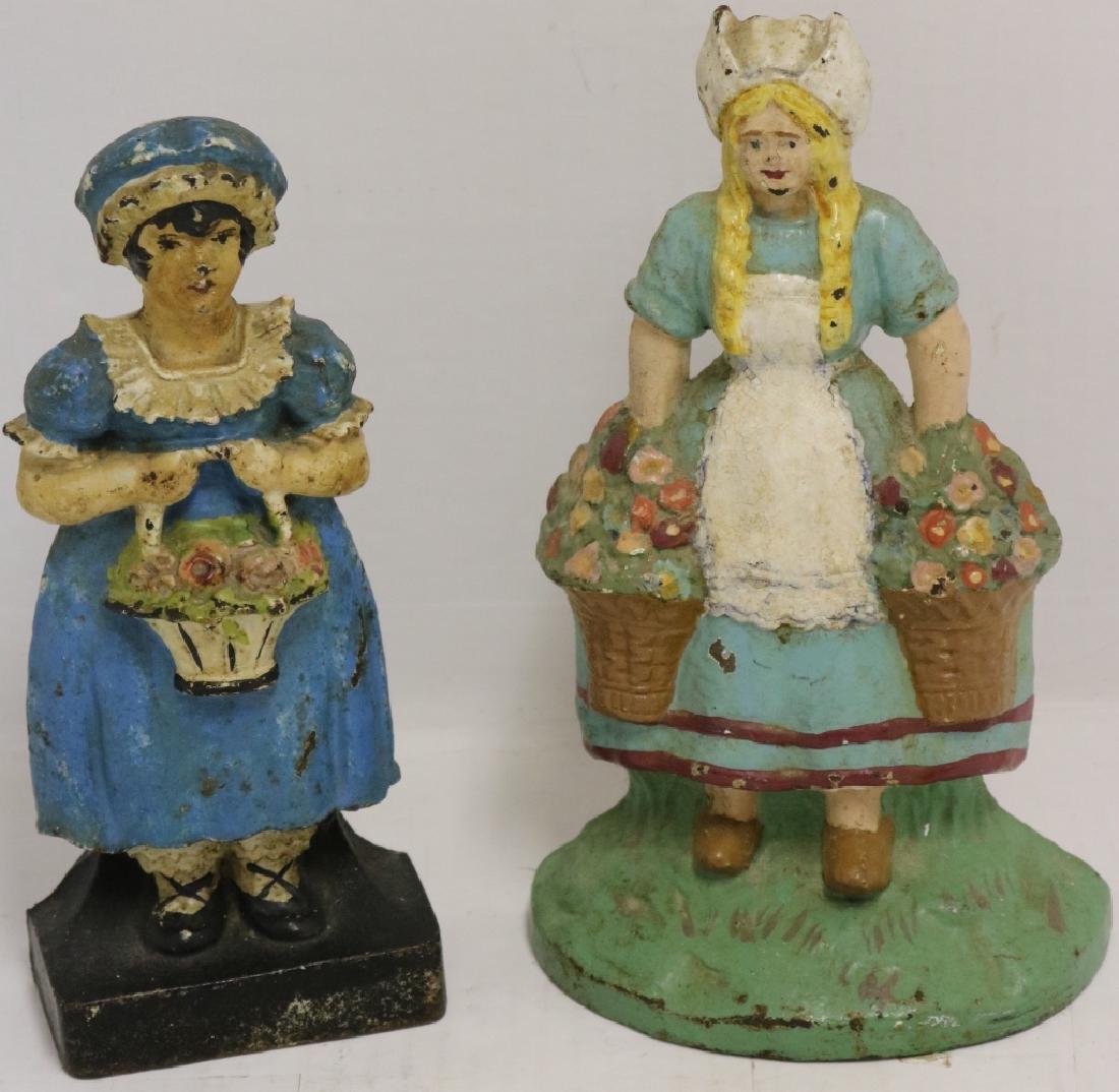 2 EARLY 20TH C CAST IRON DOORSTOPS. ONE IS A: DUTCH GIRL WITH FLOWER BASKETS, 9 1/4" HIGH WITH GOOD ORIGINAL PAINT. THE OTHER IS A COLONIAL WOMAN WITH FLOWER BASKET, 9" HIGH, GOOD ORIGINAL PAINT. PROVENANCE: FROM THE ESTATE OF MARY MCNAMEE.