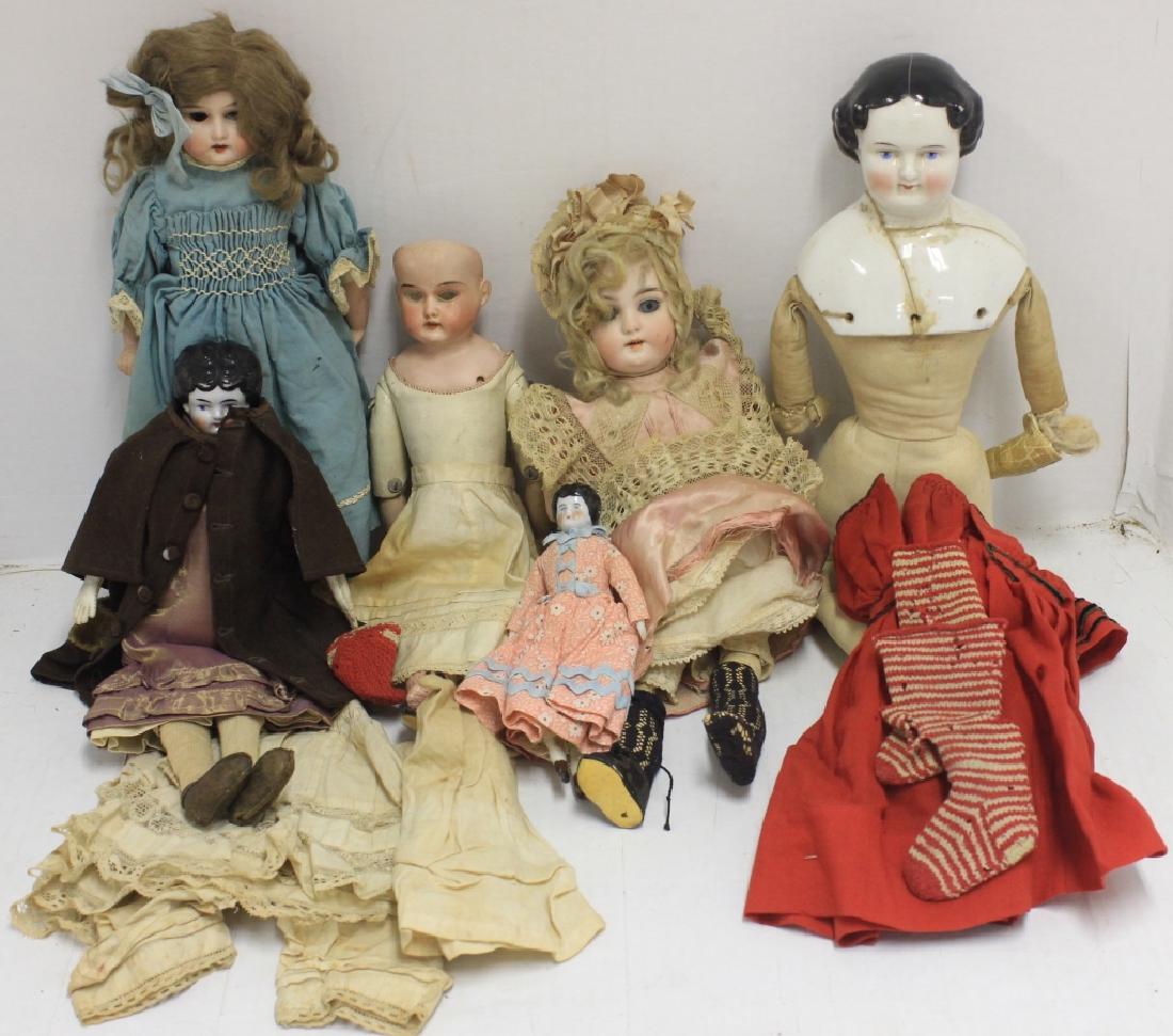 6 BISQUE AND PORCELAIN DOLLS, LATE 19TH C TO: EARLY 20TH C. THREE ARE GERMAN. 12" ONE IS A WALKER AND LEGS ARE DETACHED. 5 1/2" DOLL NEEDS RESTORATION. THREE PORCELAIN HEAD AND SHOULDER DOLLS, 7", 12", 18". LARGEST DOLL HAS EXTENSIVE REPAIR TO HE