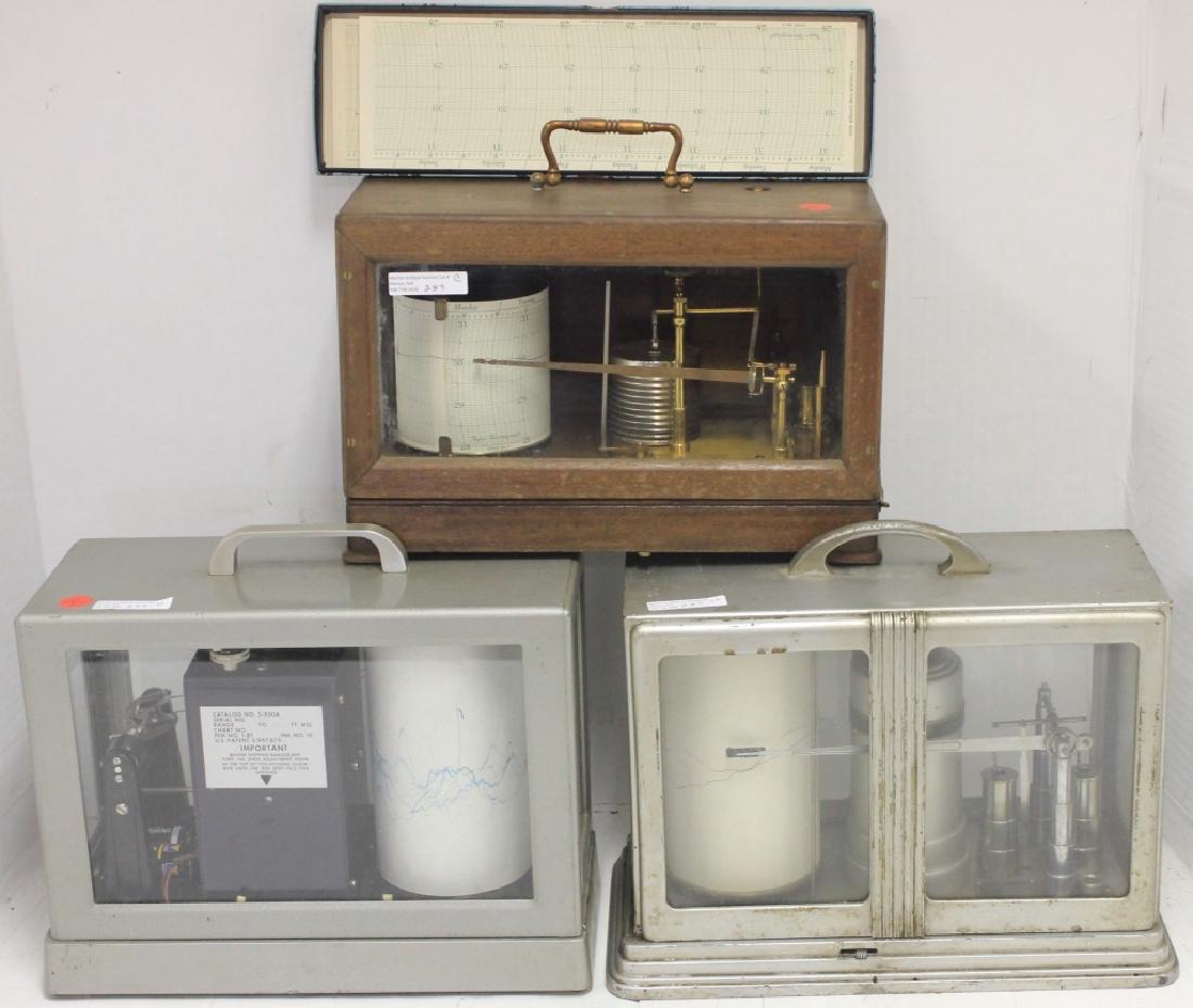 3 BAROGRAPHS TO INCLUDE AN EARLY 20TH C SHORT &: MASON, LONDON, MAHOGANY AND GLASS CASE. 2947/37/44/58. 12" WIDE, 6" D, 8" H. TAYLOR CHARTS INCLUDED. NEXT IS A JULIAN P. FRIEZ & SONS, WWII, BALTIMORE, MD., METAL AND GLASS CASE SIGNAL CORPS, U.S. ARM