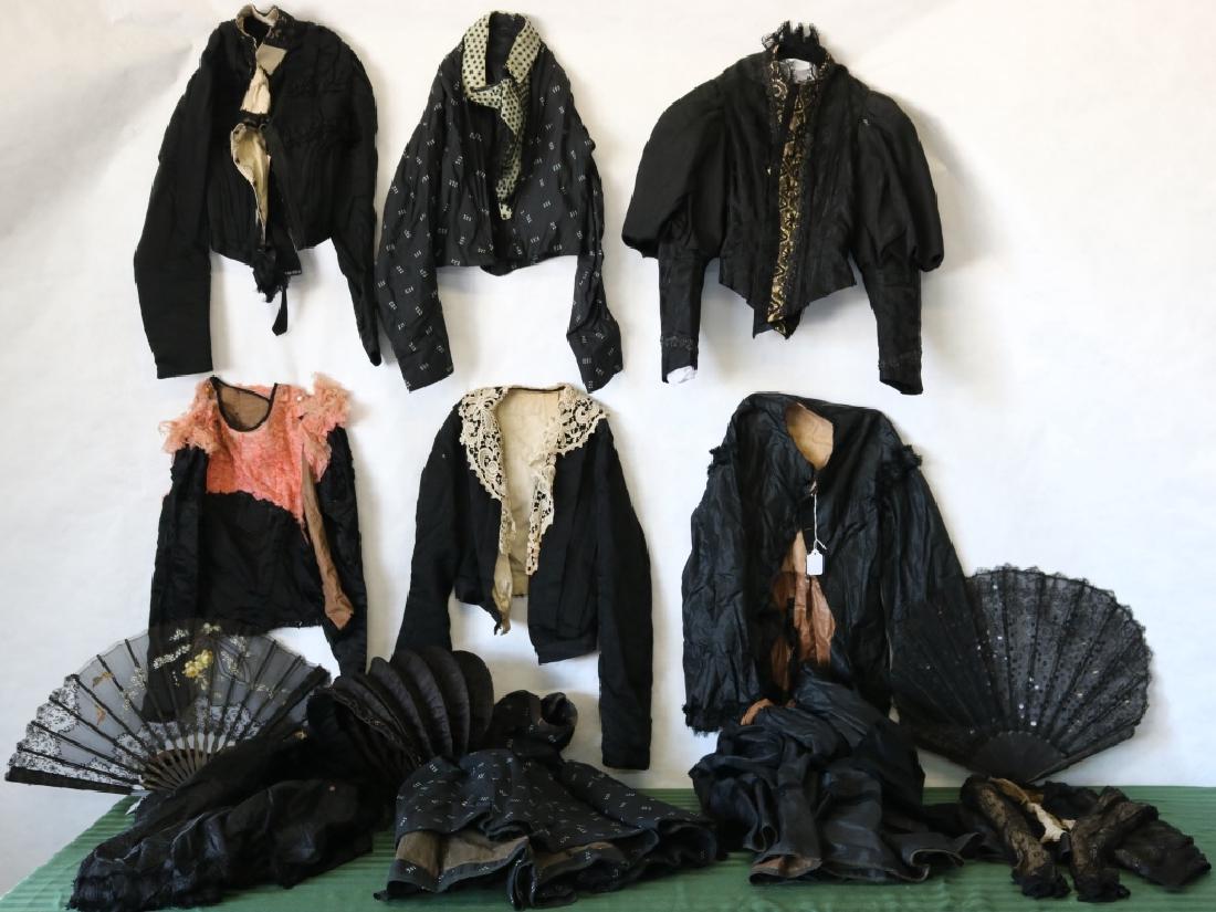 15 PIECES OF 19TH C BLACK MOURNING CLOTHING: TO INCLUDE ONE COLLAPSIBLE BONNET, ONE VEIL, 2 BODICES AND SKIRT SETS, 5 SEPARATE BODICES AND ONE BELT. GOOD CONDITION EXCEPT PINK YOKE IS SHATTERING. ALONG WITH 2 BLACK CARVED WOODEN AND LACE FANS. O