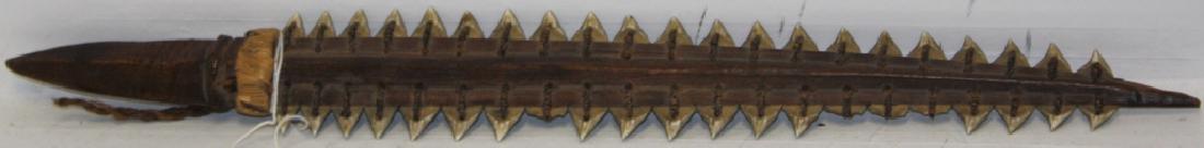 19TH C DAGGER FROM THE GILBERT ISLANDS, CARVED: WOODEN HANDLE WITH SHARK TOOTH BLADE. 17" LONG. NICE OLD PATINA. 4 BROKEN TEETH.