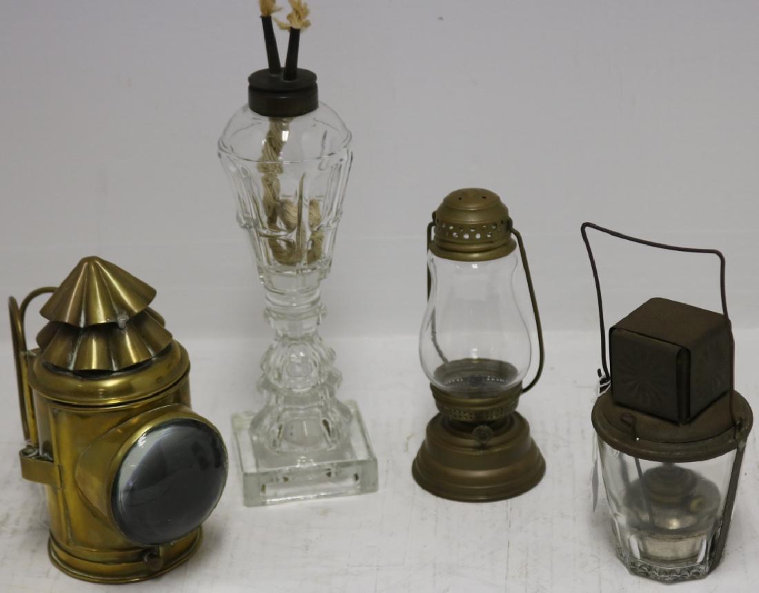 FOUR 19TH C LIGHTING DEVICES TO INCLUDE A 7 1/2": BRASS POLICE LANTERN WITH BULLS EYE, ORIGINAL BURNER, AN 11" PRESSED GLASS WHALE OIL LAMP CAMPHENE BURNER, A BRASS AND GLASS 7" SKATERS LAMP AND AN UNUSUAL TIN AND GLASS HANDLED LANTERN CALLED THE STA