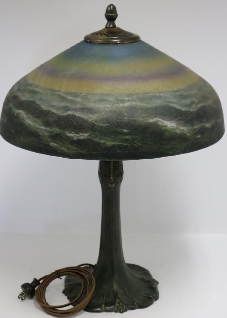 EARLY 20TH C PITTSBURGH REVERSE PAINTED LAMP.: SHADE DEPICTS OCEAN WAVES AT SUNSET, BRONZED BASE. LAMP HAS BEEN REWIRED. EXCELLENT CONDITION. 22 1/2" HIGH, 16" DIAMETER SHADE.
