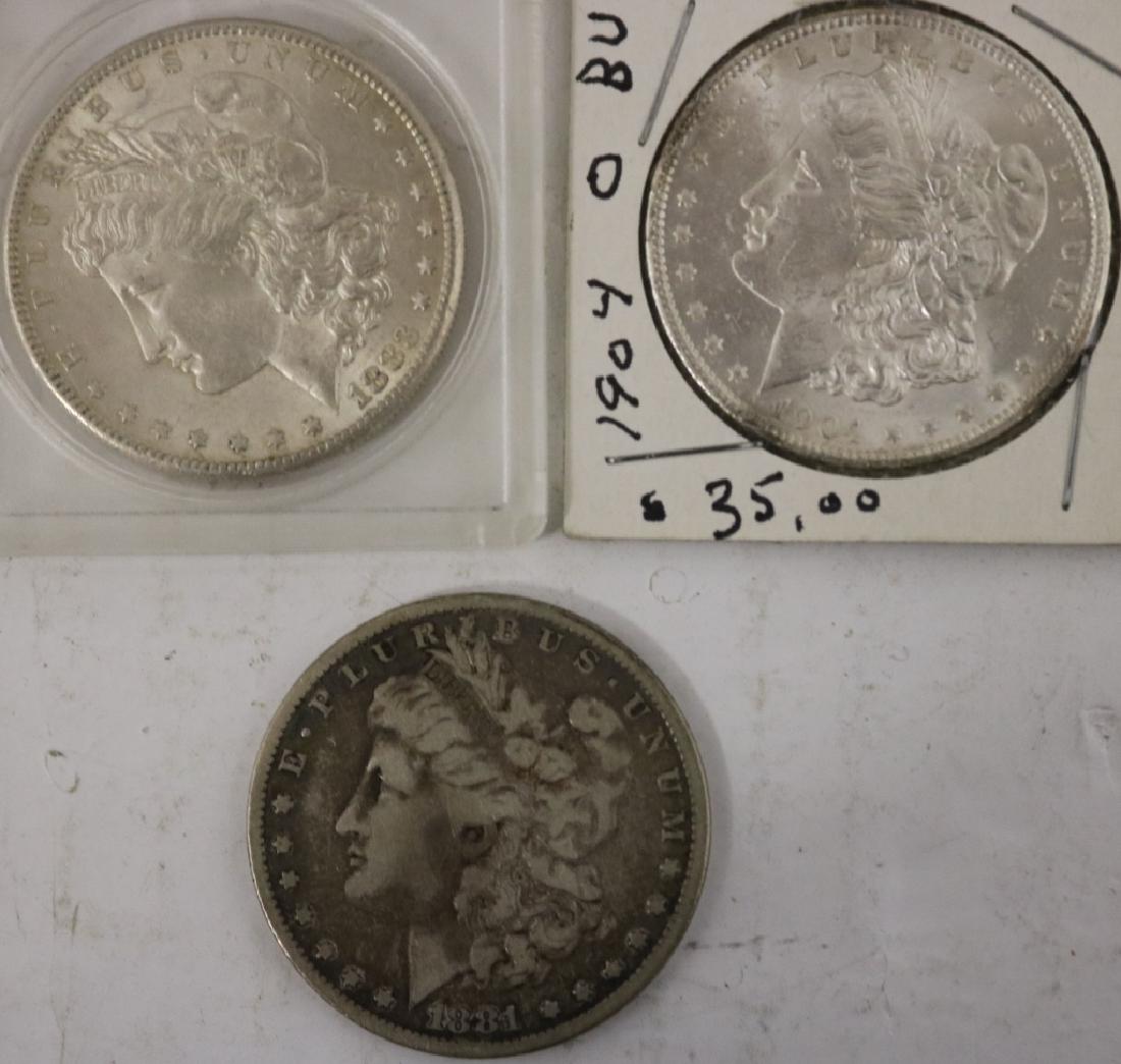 3 MORGAN SILVER DOLLARS INCLUDING A 1904-O IN BU: CONDITION, 1883-S IN BU CONDITION, 1881 IN GOOD CONDITION.