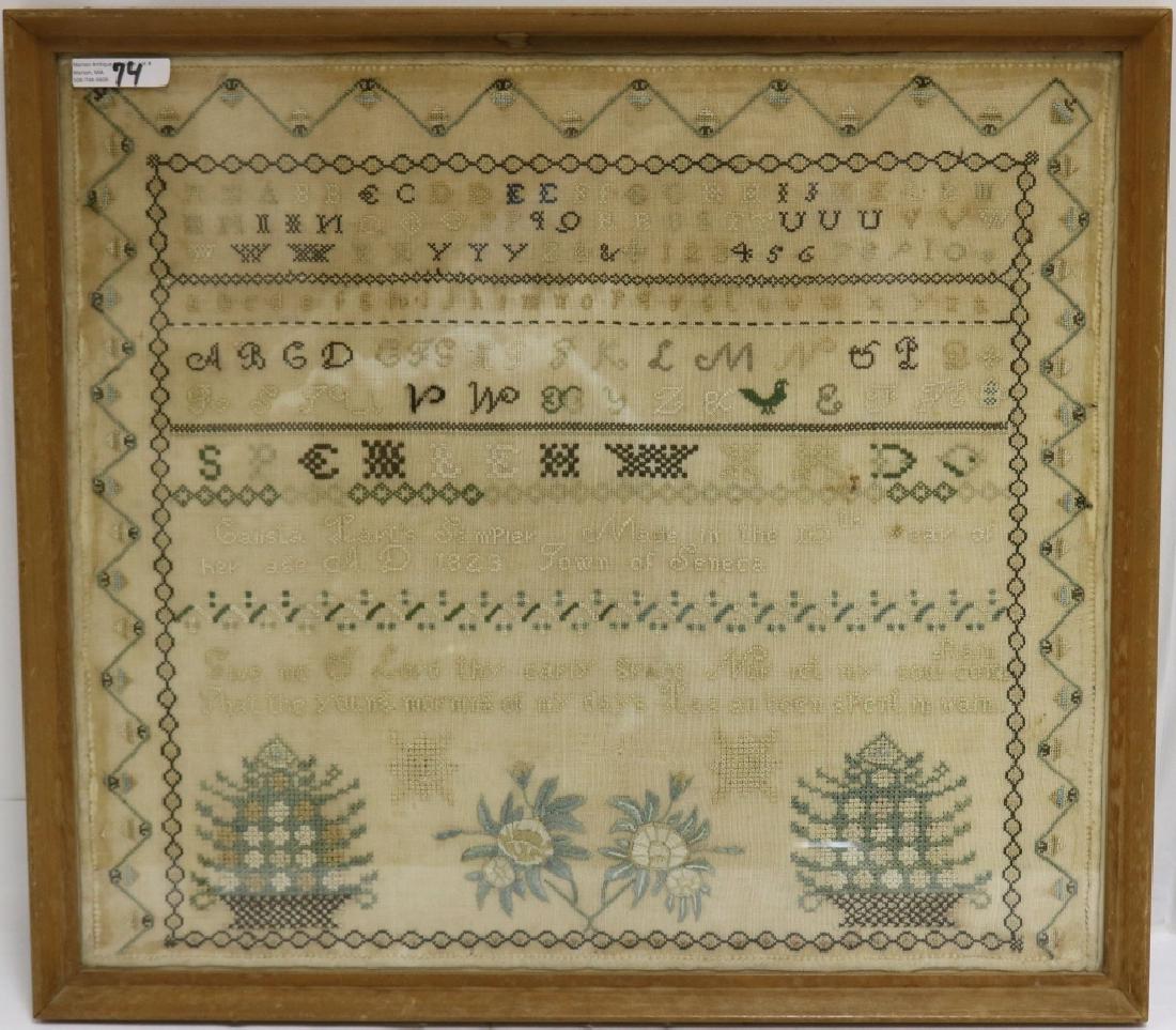 AMERICAN NEEDLEWORK SCHOOLGIRL SAMPLER BY CALISTA: HART, AGE 10. ON LINEN, TRIPLE ALPHABET WITH NUMBERS, 2 LARGE FLORAL BASKETS, MOTTO, GEOMETRIC DESIGN, 1823, SENECA, NY. VERY MINOR LOSS AND STAINING. FRAMED. SIGHT SIZE 16 3/4" X 19", OVERALL 18 1/4"