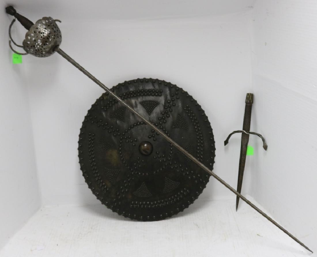 3 PIECE VICTORIAN WEAPON LOT TO INCLUDE: AN ITALIAN PONIARD DAGGER, COPY OF AN 18TH C, 14 1/2" LONG, 6" WIDE, A COPY OF AN 18TH C SPANISH CUP HILTED RAPIER, 44 1/2" LONG, 6 1/2" WIDE AT GUARD AND A COPY OF AN 18TH C SCOTTISH TARGE SHIELD, 17