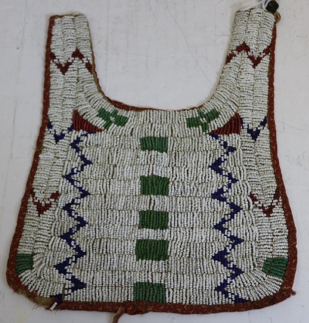 19TH C SIOUX BEADED CHILD'S BIB, FABRIC ON BACK,: SHOWS LOSS AND TEARS; 9 1/2" LONG AND 7 1/2" WIDE.