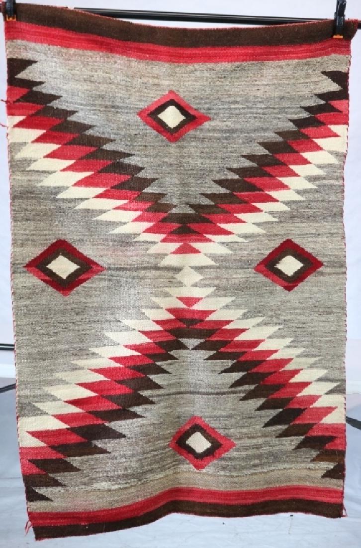 NAVAJO RUG, EARLY 20TH C CHEVRON DESIGN WITH RED,: BLACK AND GRAY COLORS. SLIGHTLY OUT OF SHAPE. 36" X 59".
